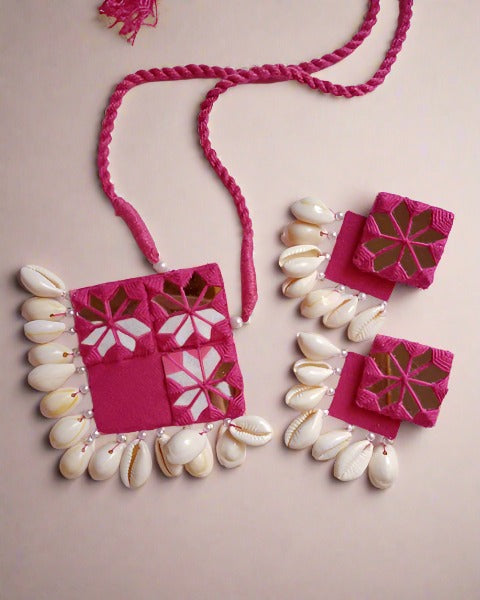 Pink kite shape necklace with mirrors and sea shells hanging 