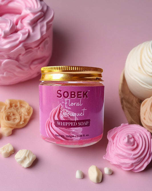Sobek naturals pink floral whipped cream soap on pink backdrop with roses around it