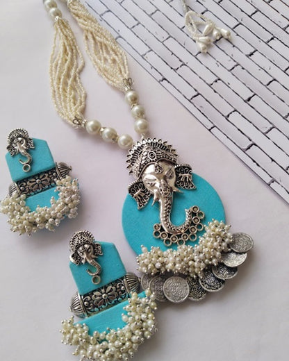 Baby blue necklace with silver ganpati charms and white beaded pearls 