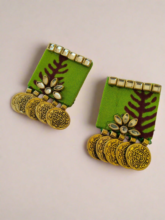 Square shape light green earrings with kundan border and golden coins at bottom on white backdrop