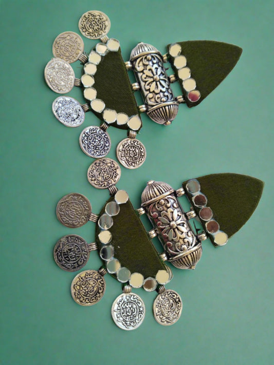 Mehendi green Indian traditional earrings with silver tabi and silver coins on white backdrop
