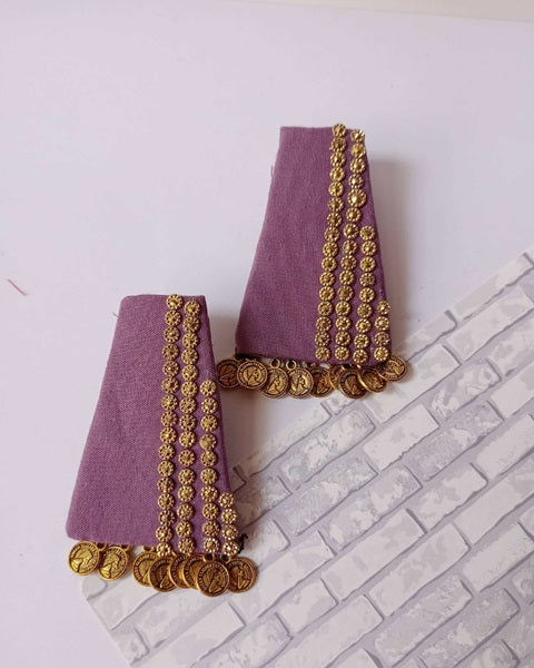 Purple fabric earrings with golden beads and coins at bottom