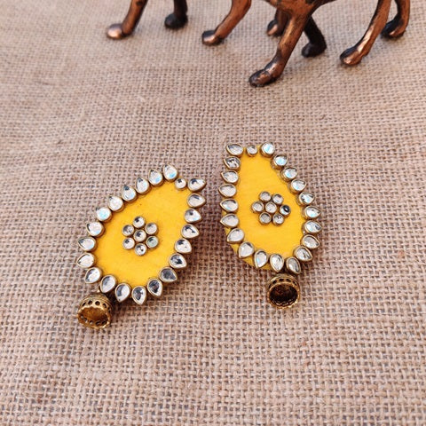 Yellow oval shape earrings with kundan borders and golden mini jhumki at bottom