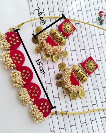 Red choker and earrings on white backdrop with its measurements mentioned