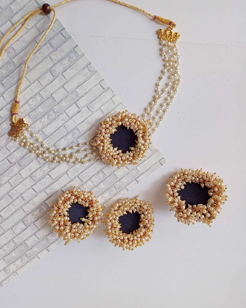 Blue choker necklace with earrings with white and golden beads 