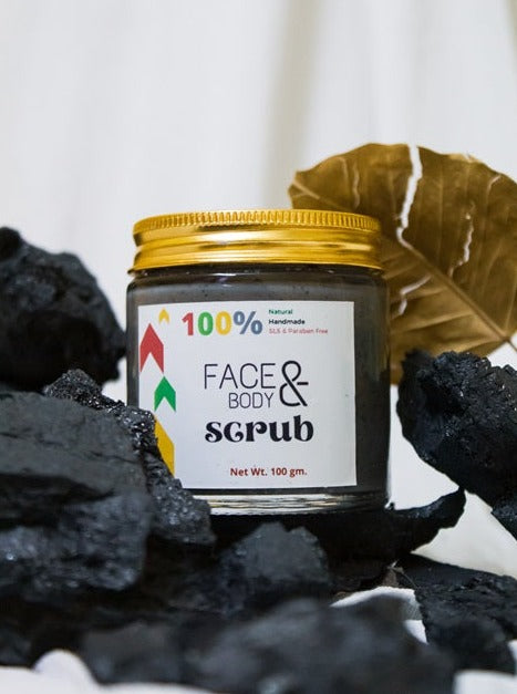 Sobek naturals glass jar with black charcoal scrub and charcoals around it