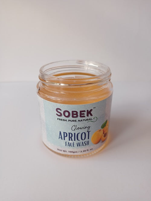 Sobek glass jar with apricot facewash on a white backdrop