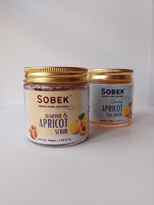 Two glass jars with sobek apricot scrubs on a white backdrop