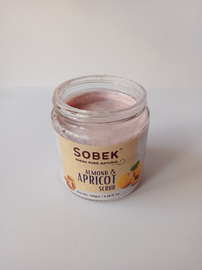 Sobek glass jar with almond and apricot pink face and body scrub on a white backdrop