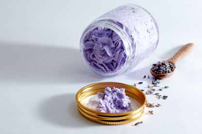 Glass jar with sobek purple whipped cream soap on white backdrop with lavender seeds
