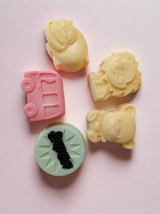 Kids toys shaped colorful soaps on a blue white backdrop 