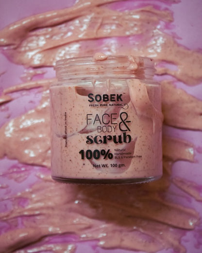 Sobek strawberry pink face and body scrub spread on pink backdrop with glass jar