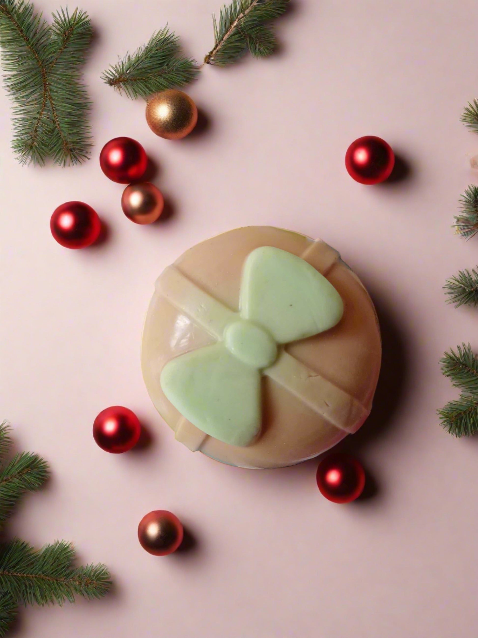 Christmas bell shaped colorful soap on a multicolor backdrop