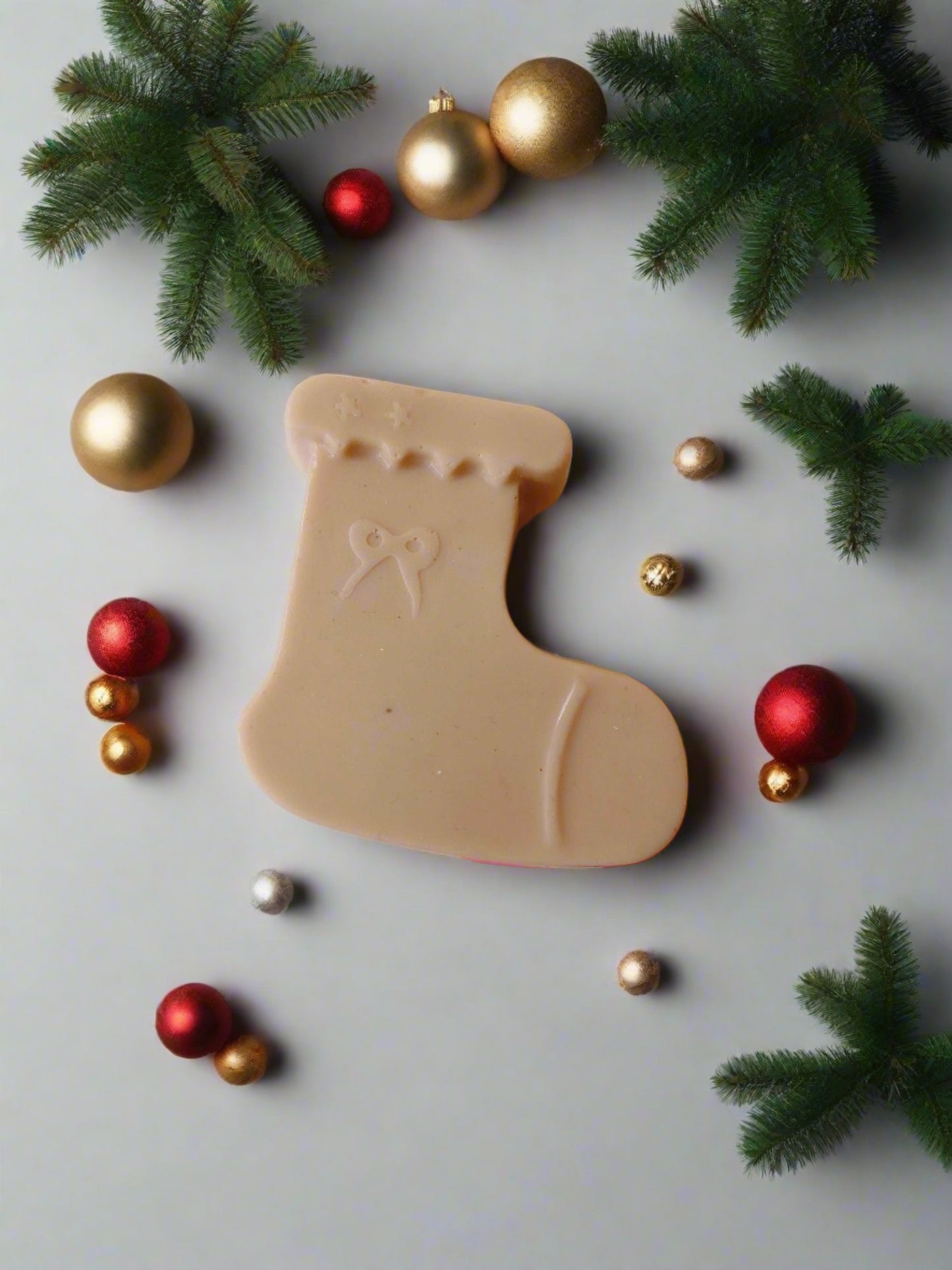 Christmas sock shaped pink soap on multicolor backdrop