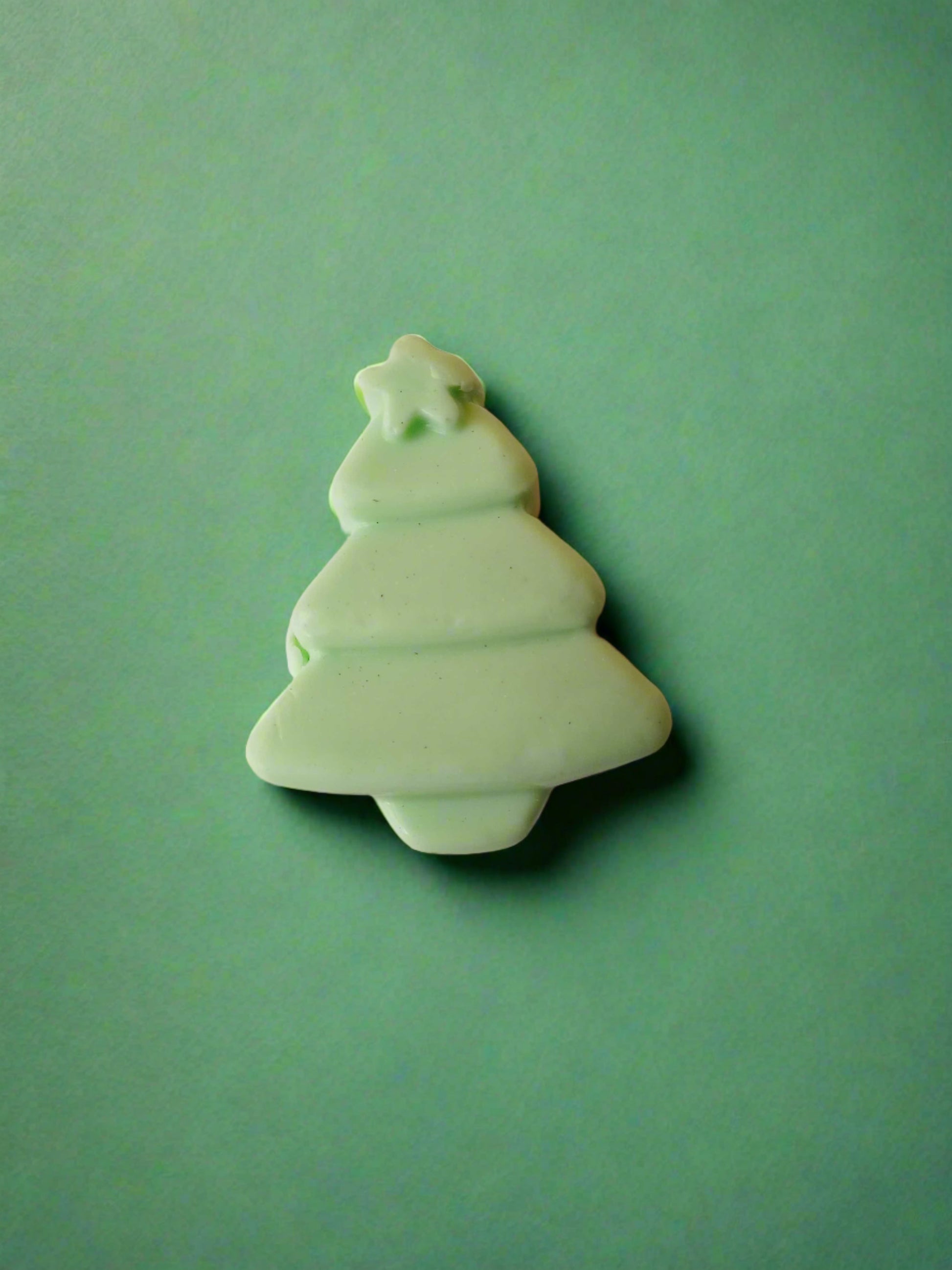 Christmas tree shaped soap in green on a multicolor backdrop