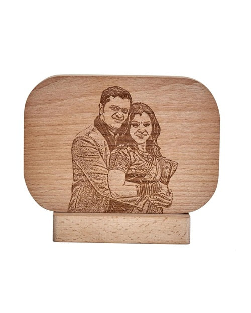 Rounded rectangular wooden frame with happy couple picture engraved on it