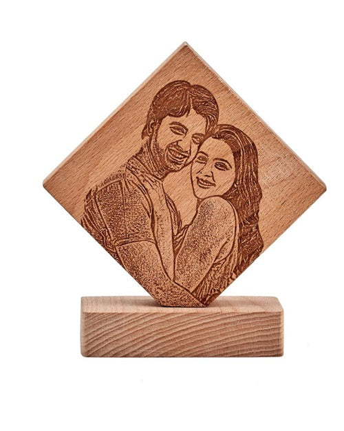Kite shaped wooden frame with happy couple's picture engraved on it