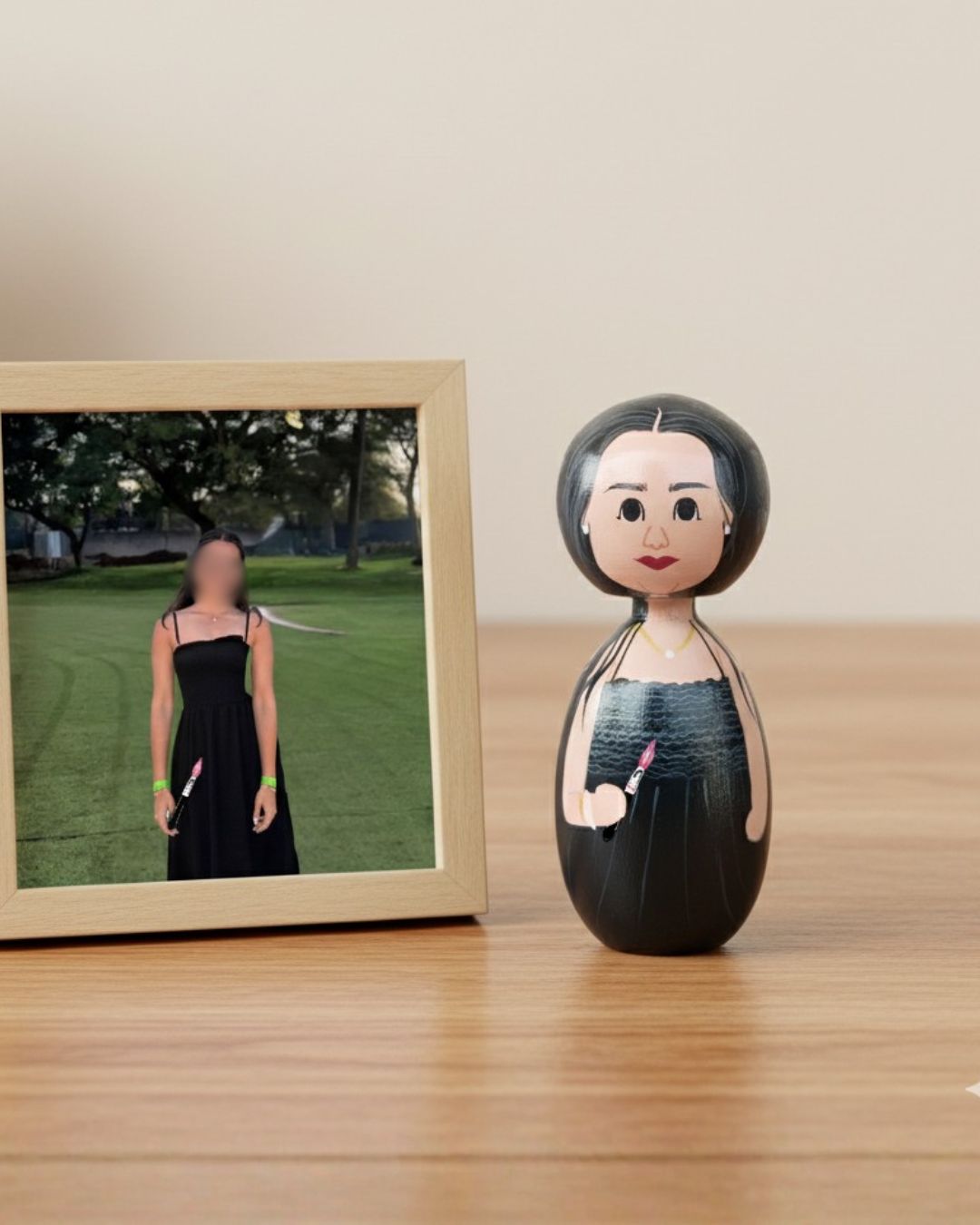 Wooden peg doll of a woman with a blurred photo in the background