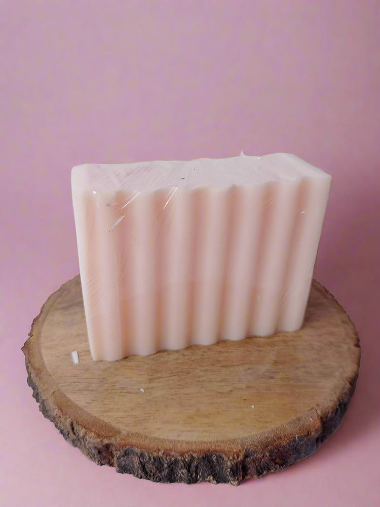 pink rectangular soap bar on white grey backdrop