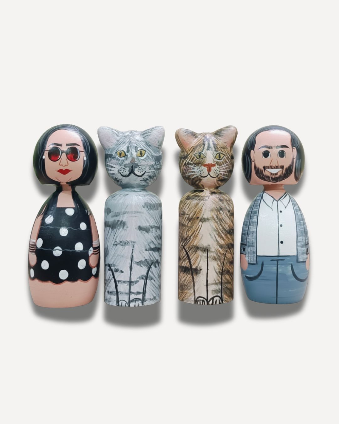 two sets of personalized wooden peg dolls