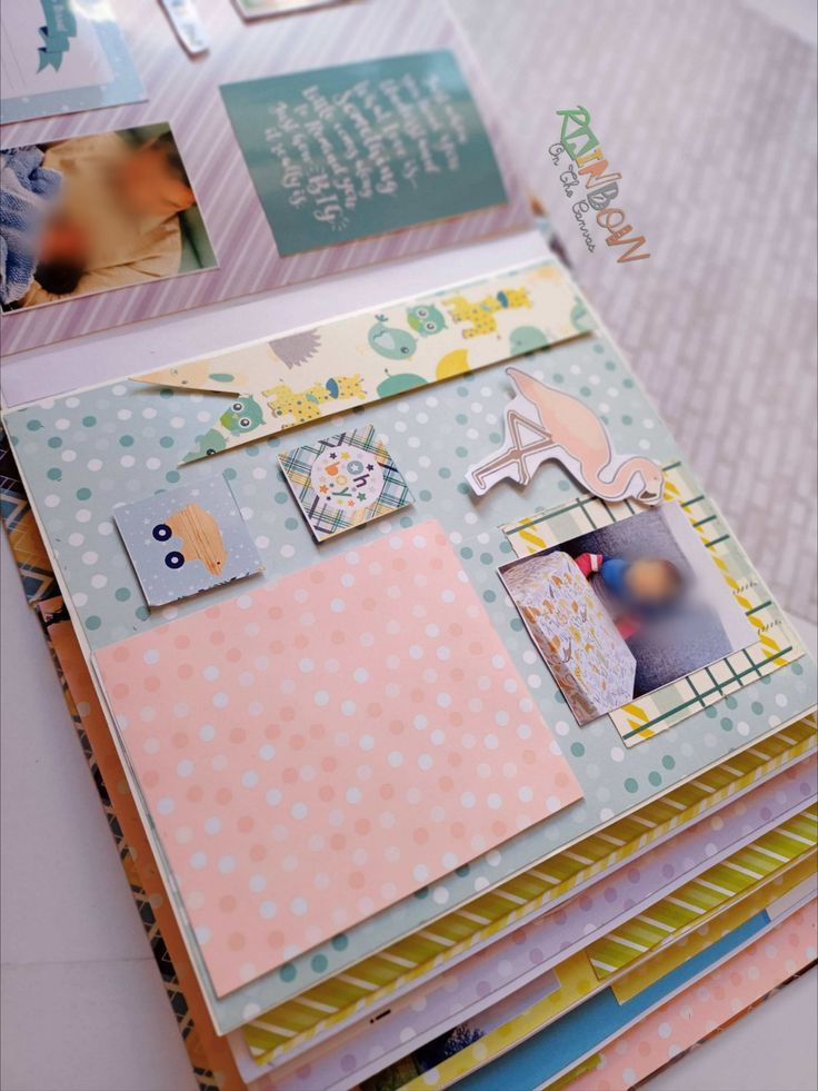 Baby birthday scrapbook in pastels on white backdrop