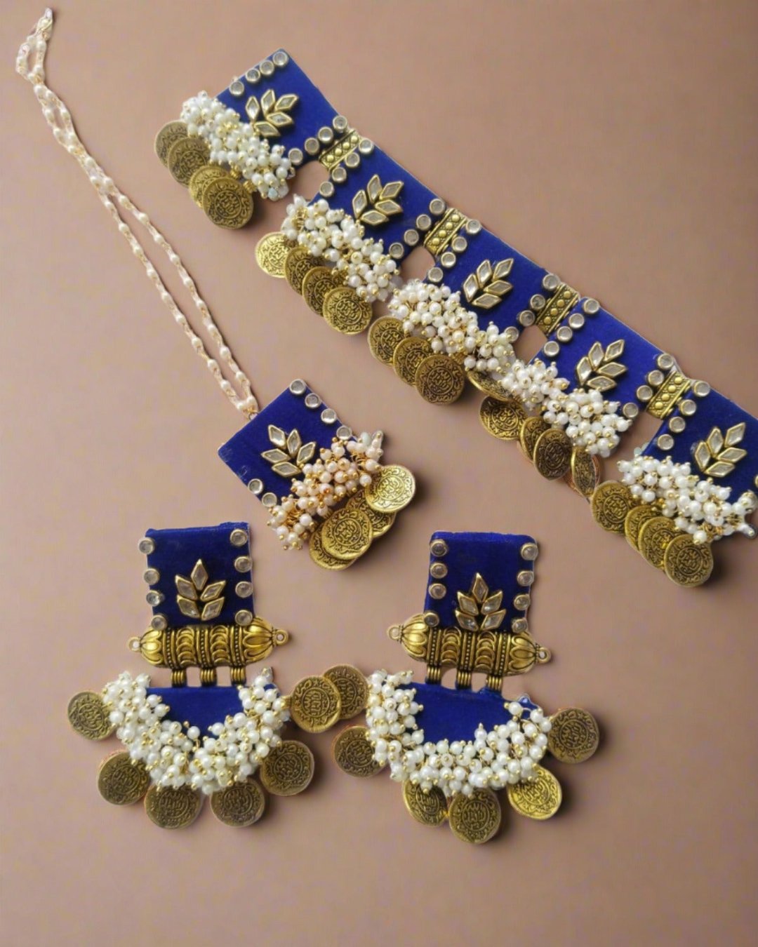 Blue and golden square choker necklace with matching earrings on white backdrop