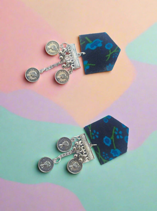 Blue floral print earrings with silver chain and coins latkan on white grey backdrop