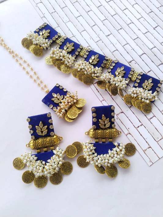 Blue and golden square choker necklace with matching earrings on white backdrop