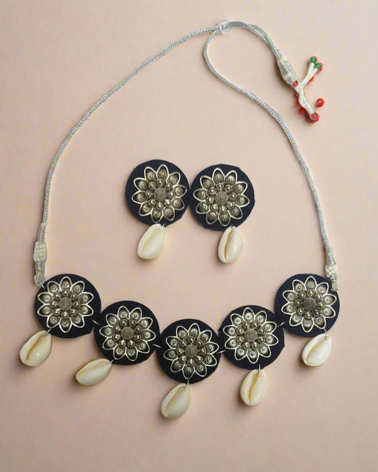 Blue round choker necklace and studs earrings with white sea shells on white backdrop