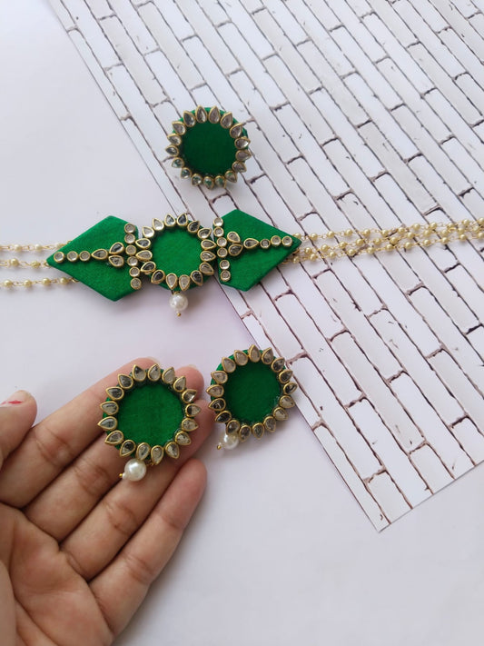 Green and silver kundan necklace earrings set on white backdrop