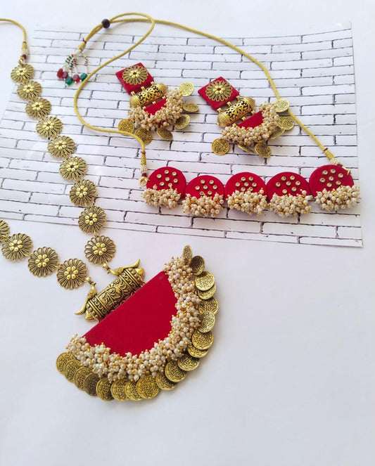 Hot red necklace with silver chain and semi round locket with matching choker and earrings on white backdrop