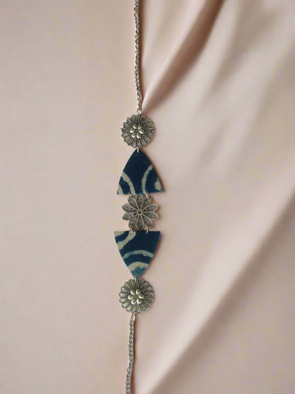 Indigo blue printed triangular choker necklace with silver charms on white backdrop