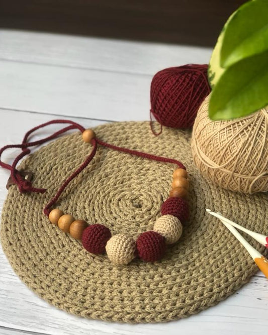 Maroon and beige crochet beaded round necklace on brown crochet base with wool 