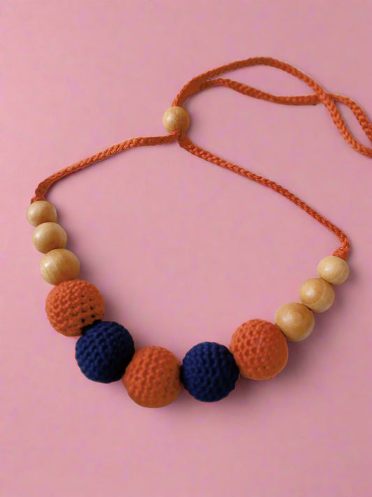 Maroon and blue crochet round beaded choker necklace on white backdrop