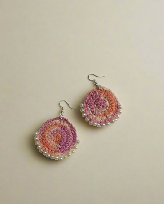 Pink and peach crochet round bali earrings on white grey backdrop