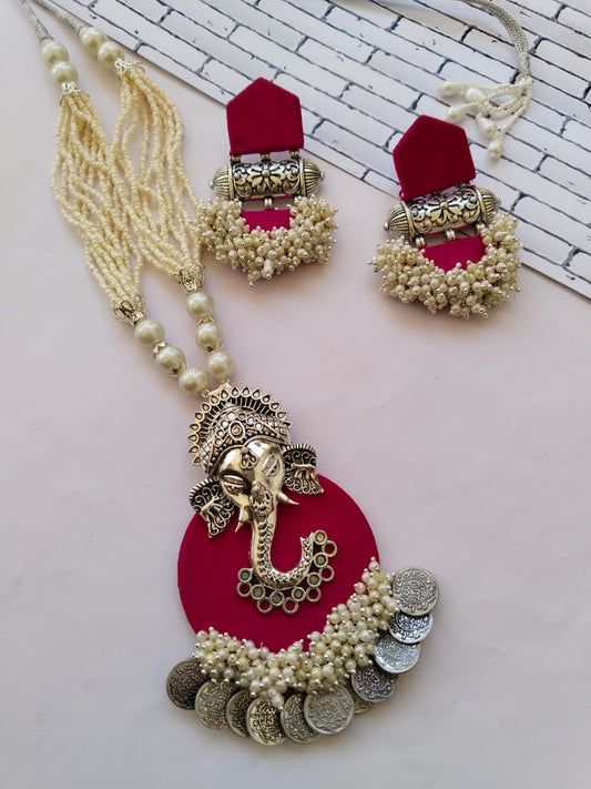 Dark pink necklace pendant with ganpati charm, white beads and silver coins and matching earrings