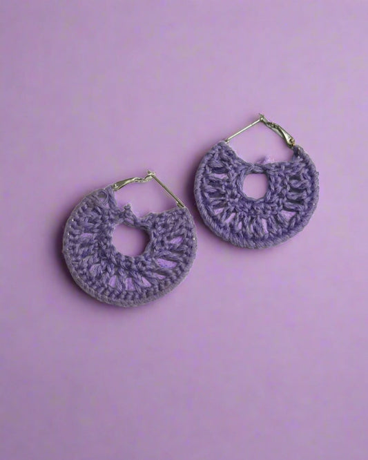 Purple crochet hoops earrings on white grey backdrop