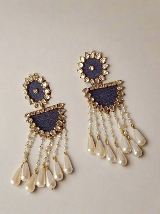 Purple earrings with white and golden pearls and latkan on white backdrop
