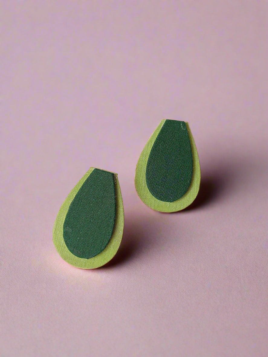 Light and dark green avocado shaped studs earrings on a white backdrop