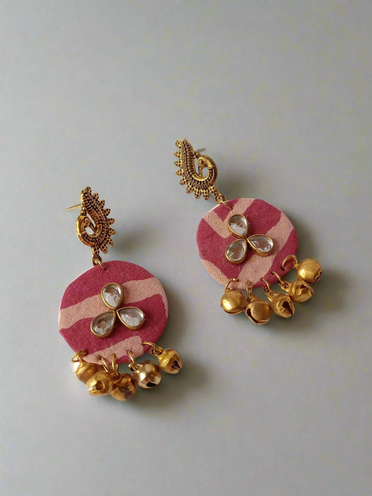 Round leheriya print jhumka earrings with kundan and golden ghungroo on white backdrop