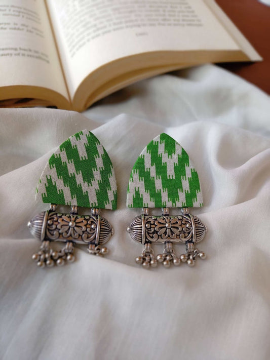 Printed light green earrings with silver charm and ghungroos on white backdrop