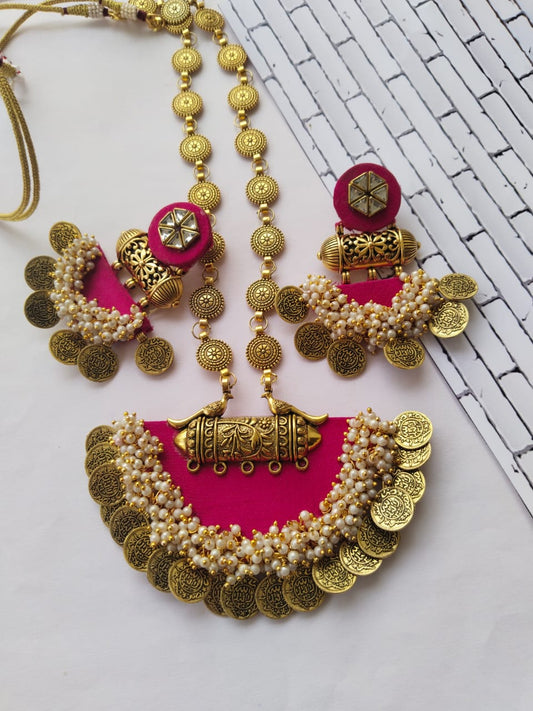 Magenta pink semi round necklace with matching earrings with golden beads and coins on white backdrop