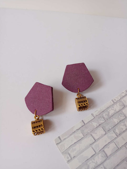 Purple rounded plain earrings with golden jhumki on white backdrop