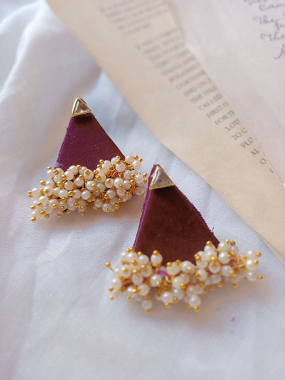 Purple wine color triangular studs earrings with golden beads on white backdrop