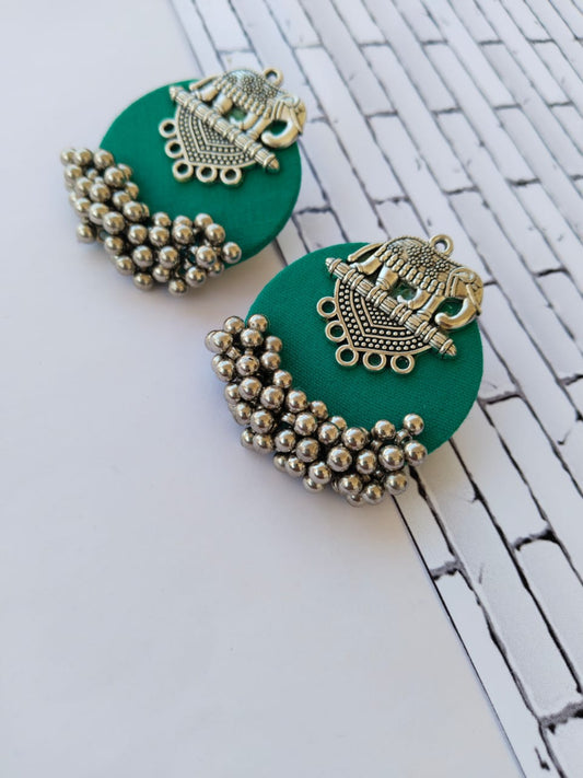 Sea green round studs earrings with silver elephant charm and beads on white backdrop