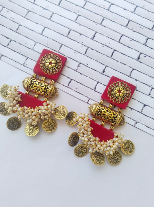 Red square and semi round earrings with golden tabiz, beads and coins on white backdrop
