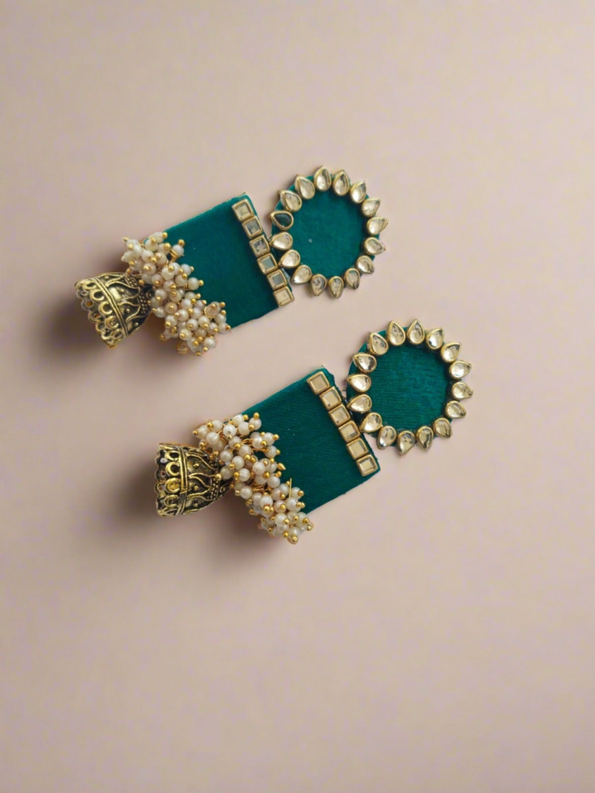 Sea green rectangular jhumka with white and golden beads on white grey backdrop