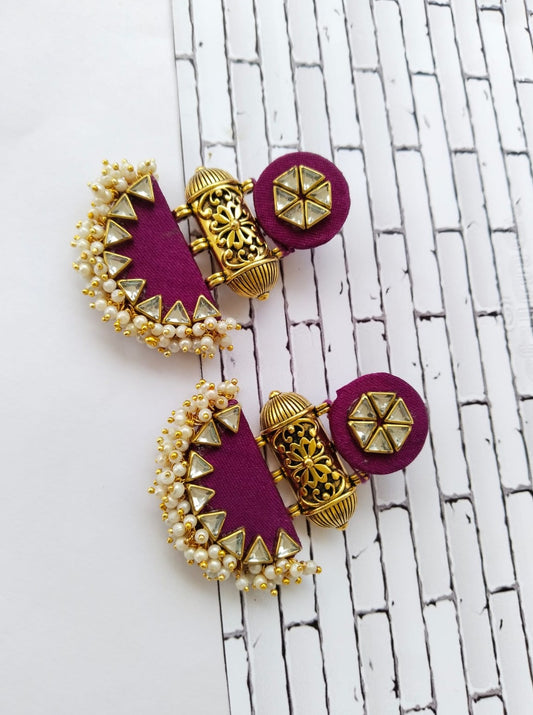 Wine purple earrings with golden beads and tabiz on white backdrop